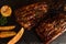 Food background of BBQ barbeque pork ribs served with potato fried and baked corn, selective focus