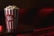 Food background of big cup or bucket of popcorn to eat as snack in cinema theater