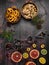 Food background with christmas spices, dried apples, nuts, citrus fruits, cydonia, cranberries, raisin, and baking dish on wooden