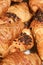 Food background - closeup of a collection of croissants with poppy seeds.