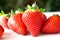 Food background .Closeup on a freshly organic red ripe strawberries lying on a white background.Summer ripe berries.Delicious frui