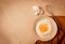 Food background, concept, plate with wheat flour, broken egg, whisk, kitchen towel, on a beige table, top view, rustic,