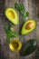 food background with fresh organic avocado, lime, parsley and olive oil