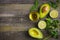 food background with fresh organic avocado, lime, parsley and olive oil