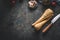 Food background with fresh parsnips roots on dark kitchen tables with knife. Top view. Vegetables cooking concept