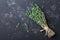 Food background of herb thyme on black kitchen table from above.