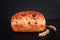 Food background Organic French whole wheat Raisin bread on black background plate