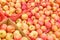 Food background red with yellow apples in boxes, fruits on a store shelf close-up