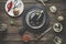 Food background with two eggplants on dark cutting board at rustic wooden kitchen table with spices, kitchen utensils and