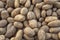 Food background of unwashed Organic potatoes on a market stall. Weekly spanish marketplace