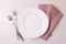Food background. White empty plate, cutlery, napkin. Top view, c