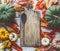 Food background with wooden cutting board, cooking spoon and colorful organic farm pumpkins, top view with copy space for your des