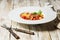 Food banner. Appetizing penne pasta with tomatoes, spices, Parmesan cheese and fresh basil. Dish of classic Italian cuisine in a