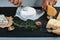 Food banner chef slicer camembert cheese on a black stone board with a twig of rosemary, walnut, Side view photo, overhead. set