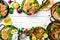 Food banner: pasta, chicken, pumpkin, salad, meat, mushrooms. On a white wooden background. Top view. Free space for text