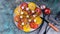Food banner Tasty red and yellow tomatoes with onions, mozzarella cheese, salt and spices on a round plate