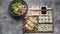 Food banner: tasty traditional Asian food. Vegetable sushi maki rolls, gyoza dumplings with salad on a black stone board. Pork