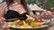 food on the beach a chic restaurant in Albanian resort Ksemil a girl eats fish and fries with knife and fork young woman