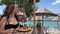 food on the beach a chic restaurant in Albanian resort Ksemil a girl eats fish and fries with knife and fork young woman