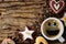 Food and beverage background of a cup of black coffee with smling face and assortment of cookies and roasted arabica coffee beans