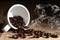 Food and beverage background of roasted coffee beans in coffee cup and scattered around with aroma smoke