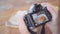 Food blogger Asian woman using camera for photo dessert, bread and drink while sitting on table in cafe.