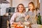 Food blogger mother and daughter preparing cookies together in quarantine lockdown for Coronavirus Covid19