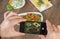 Food blogger using smartphone taking photo .Mans hands make phone photography of traditional meals.