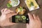 Food blogger using smartphone taking photo .Mans hands make phone photography of traditional meals.