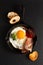 Food Breakfast concept fried egg in skillet iron pan with flax sprouts and bacon with copy space