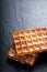 Food concept Classic square Waffles with icing sugat toping on b