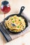 Food concept homemade spaghetti creamy white sauce in cast-iron skillet pan on wood