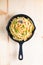 Food concept homemade spaghetti creamy white sauce in cast-iron skillet pan on wood