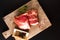 Food concept piece boneless Pork collar on cutting board with spice on black background with copy space