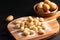 Food concept Spot focus homemade gnocchi on wooden board on black background with copy space