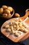 Food concept Spot focus homemade gnocchi on wooden board on black background with copy space