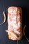 Food concept top view Fresh homemade loaf of organic crusty artisan  bread on black slate stone background