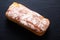 Food concept top view Fresh homemade loaf of organic crusty artisan  bread on black slate stone background