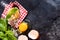 Food Cooking concept background. Ingredients for traditional Italian homemade pasta tomatoes, raw egg, basil leaf on the dark