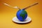 Food crisis on the planet concept. globe on a plate and a fork with a knife. 3D render