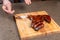 Food, delicious and craft concept - Man cutting horse steak