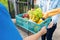 Food Deliver Asian man in blue uniform give fruit and vegetable to receiver customer front house