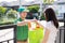 Food Deliver Asian man in green uniform give fruit and vegetable to receiver customer front house