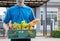 Food Deliver Asian man wearing mask in uniform give fruit and vegetable to receiver customer front house