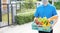 Food Deliver Asian man wearing mask in uniform give fruit and vegetable to receiver customer front house