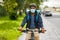 food delivery man in mask with bag riding bicycle
