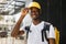 Food delivery, portrait of courier african man with yellow backpack and cap.