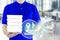 Food delivery service or order food online. Delivery man in blue uniform with hand holding fast food packaging container and icon