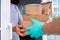 Food delivery staff is wear gloves to prevent germs while delivering