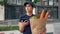 Food delivery woman courier uses smartphone holds paper bag looking address